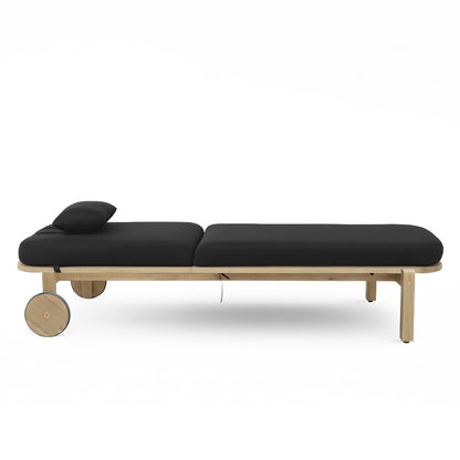 Zyra Hardwood Reclining Sun Lounger with Cushion in Black features a wooden frame, two large round wheels, thick black cushions, and a small headrest pillow, ideal for outdoor relaxation.