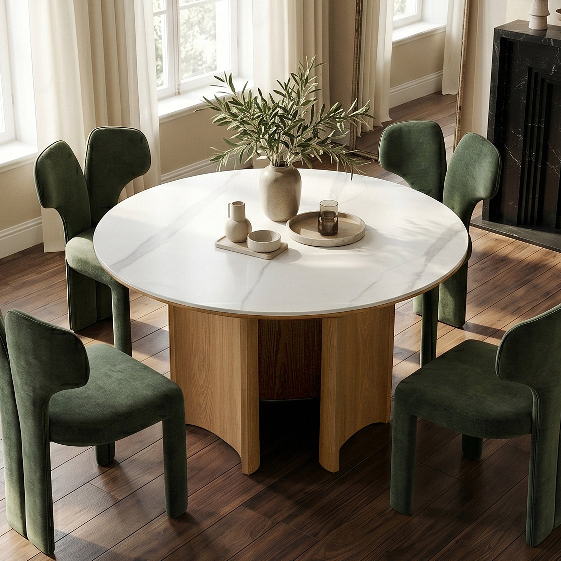 Round dining table with white top and green chairs in a stylish dining room