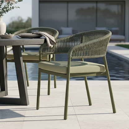 Coastal Outdoor Rope Dining Chairs Set of 2 in Green, featuring olive-green metal frames with woven rope backs and seat cushions, set by a poolside dining area with a modern aesthetic.