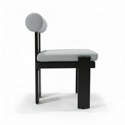 Positano 6 Seater Outdoor Dining Set in Black & Grey features a sleek, minimalist chair with a black metal frame, light-gray cushions, and a cylindrical backrest, embodying modern outdoor elegance.