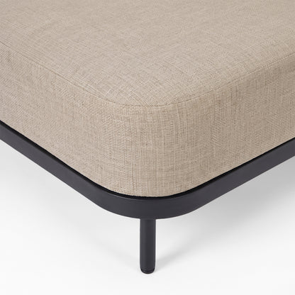 Close-up of upholstered furniture corner with metal leg on white background.