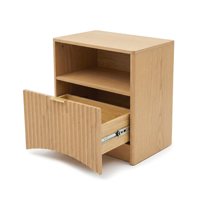 Light oak nightstand with open shelf and partially open lower drawer on white background.