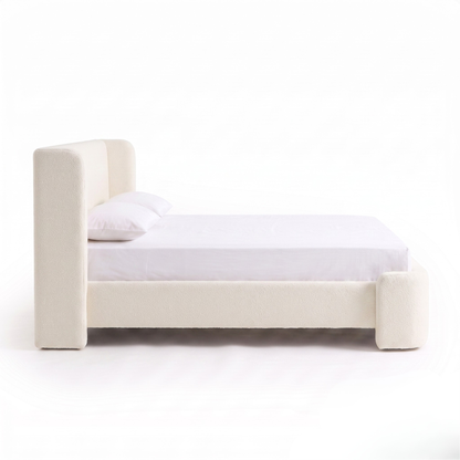 Side view of upholstered bed on a white background