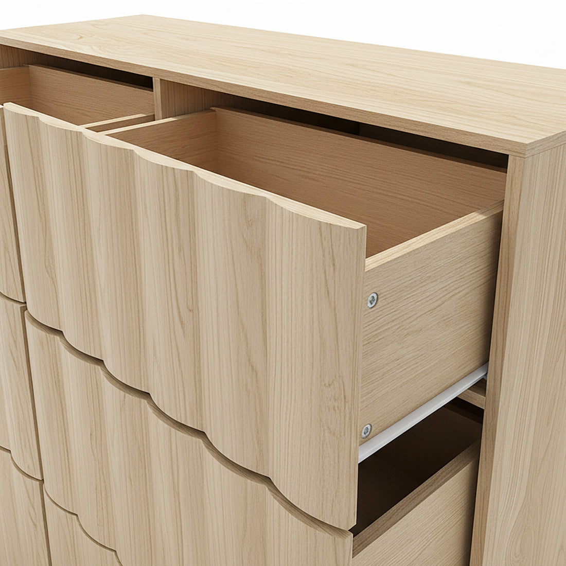Upper portion of light wood dresser with partially open drawers on white background