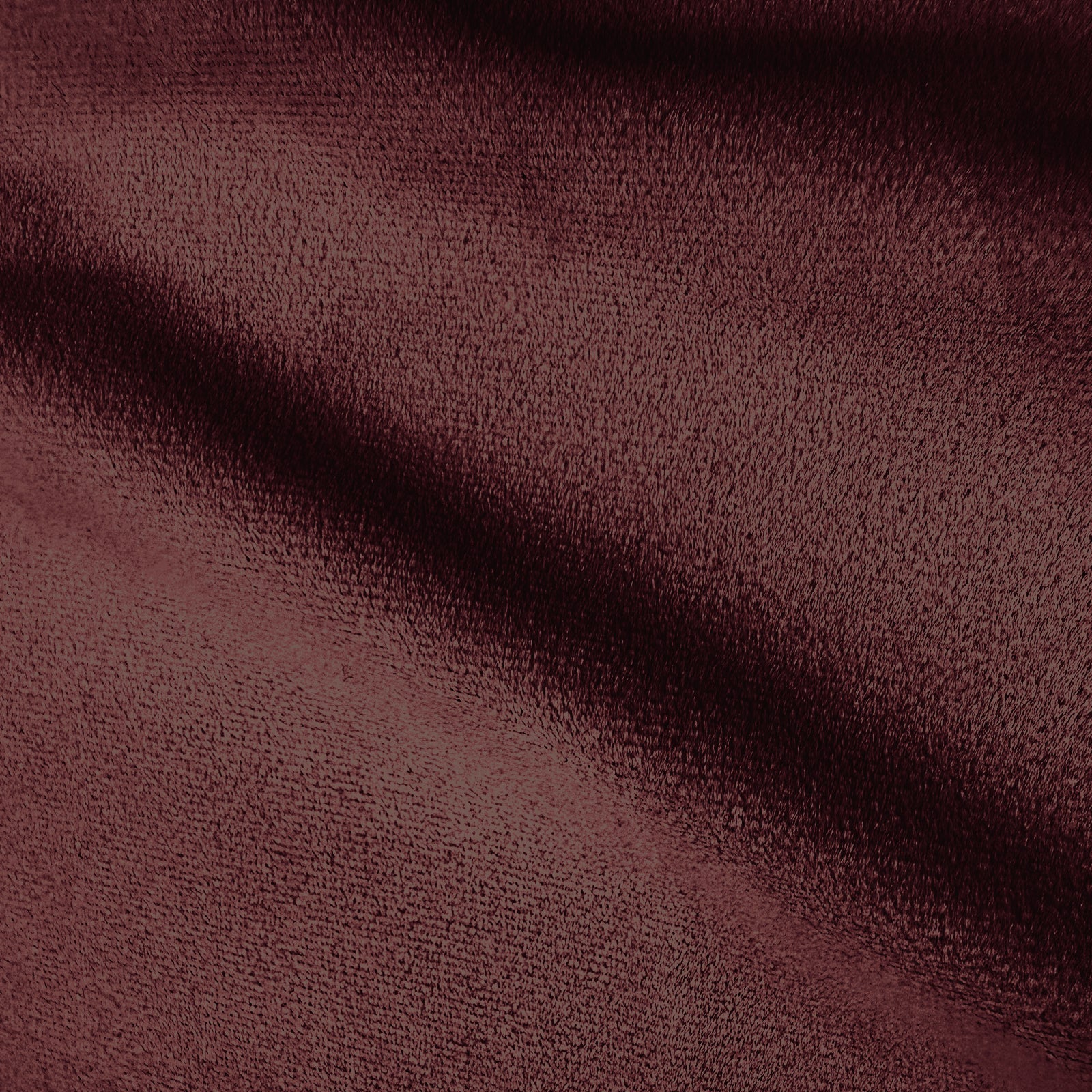 Extreme close-up of burgundy velvet fabric texture