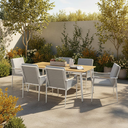 Casara 7 Piece Outdoor Dining Set in White & Grey features a light wood-tone table, six woven chairs, and a succulent planter, set in a sunlit garden patio for serene outdoor dining.