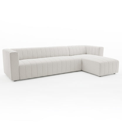Parisa 4 Seater Tufted Boucle Sofa with Chaise in Cream White features an L-shaped design, light boucle fabric, vertical channel tufting, and low-profile, nearly concealed feet for a minimalist aesthetic.