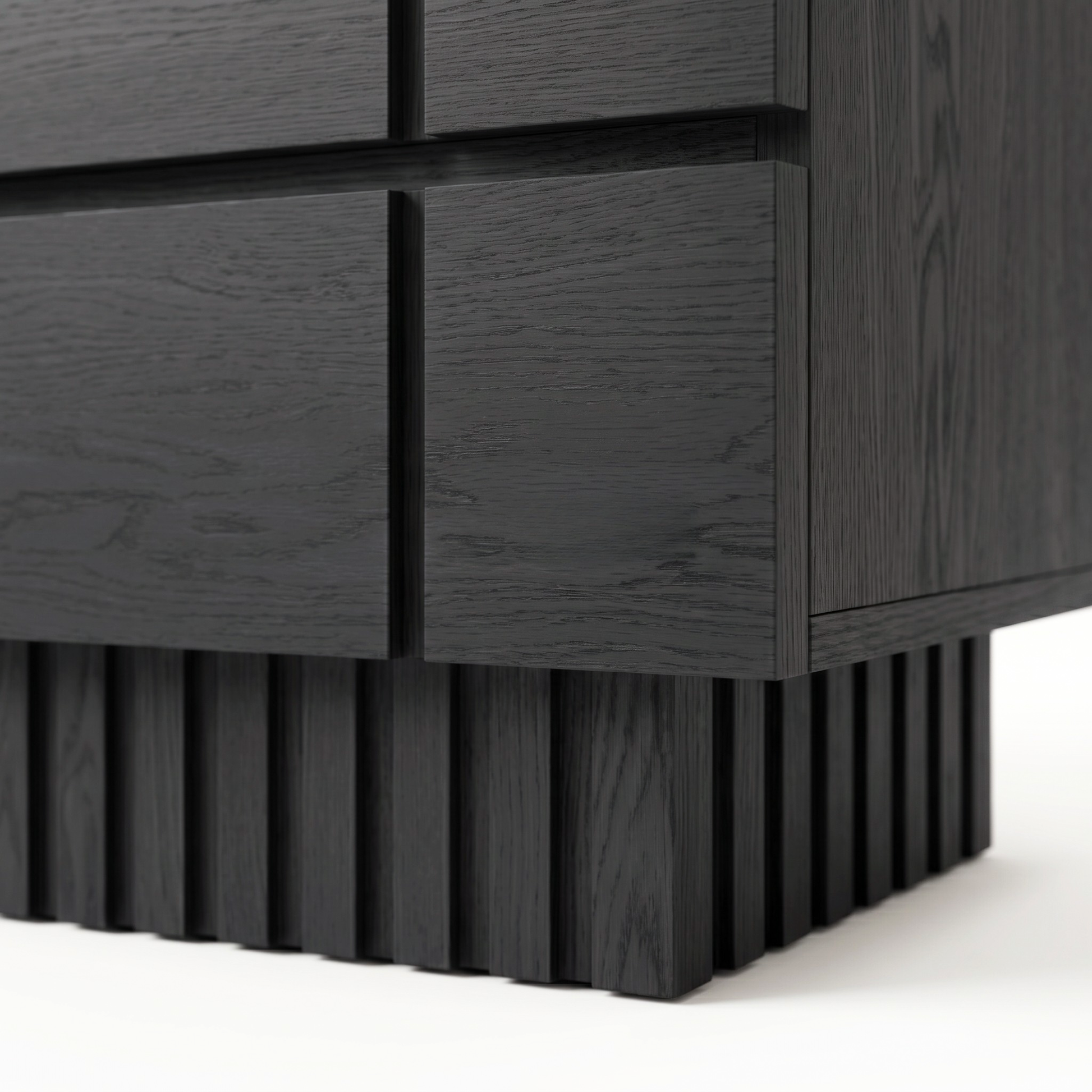 Close-up of the lower corner and textured base of a black wooden nightstand