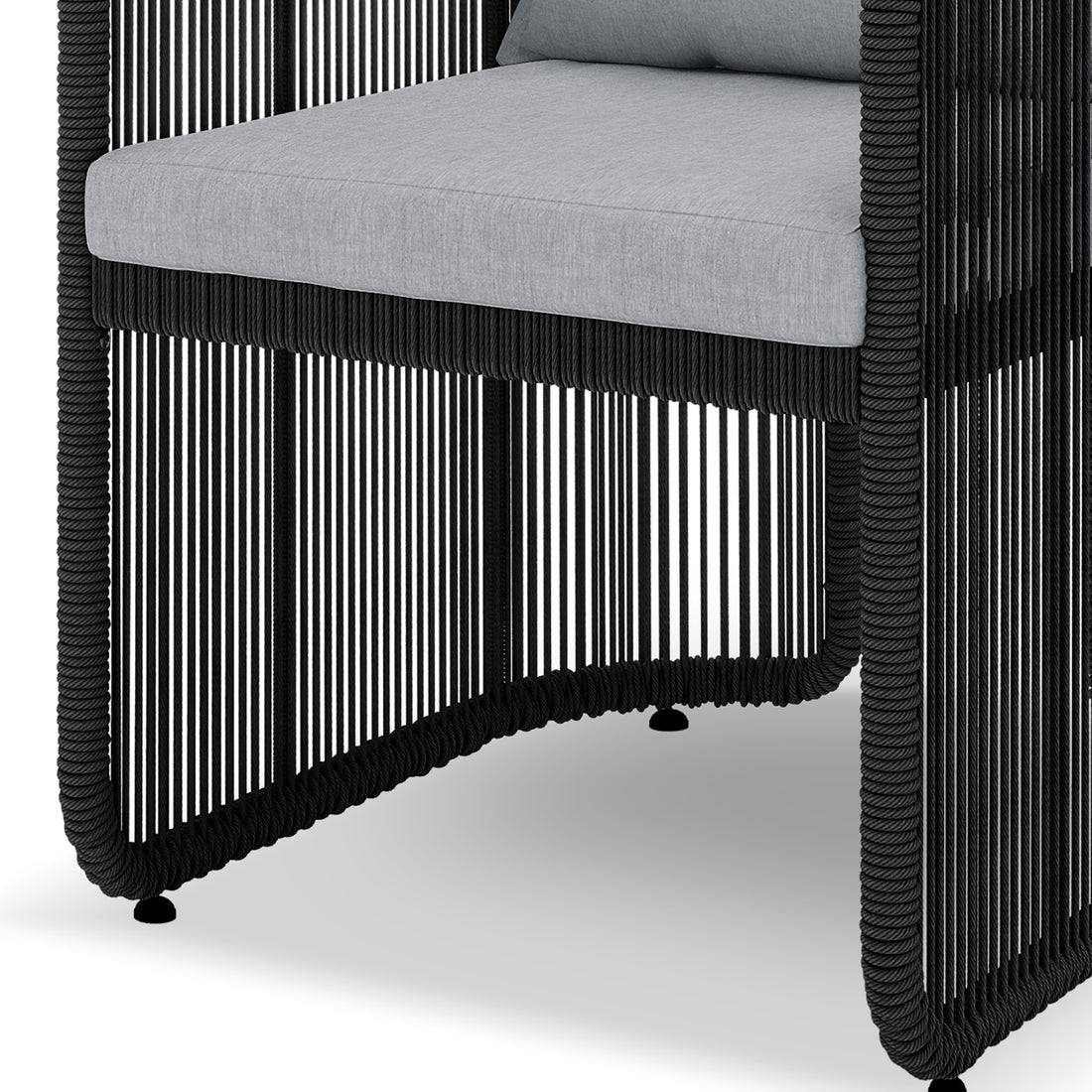 Vellora 4 Seater Wicker Outdoor Dining Set in Black, showcasing a chair's black rope frame and light-grey cushion, highlighting its semi-open skirt and curved apron design.