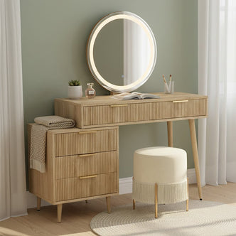 Serenity Dressing Table with Touch Screen Mirror in Natural features a light-wood vanity, LED-lit round mirror, ribbed drawers, and cream stool with gold legs, creating a sleek, organized beauty space.