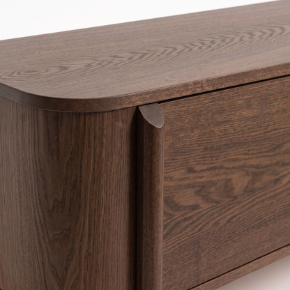 Close-up of a dark wood furniture corner and side on a white background.