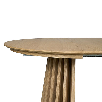 Close partial view of a wooden table top and base on a white background