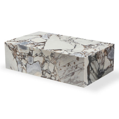 The Solene 100cm Coffee Table in Blue Galaxy showcases a polished marble-like block with unique veining, featuring sharp, clean edges. Its elegant design epitomizes sophistication and practicality for modern living spaces.