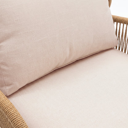 Close-up of a cushioned furniture section with woven frame detail on a white background