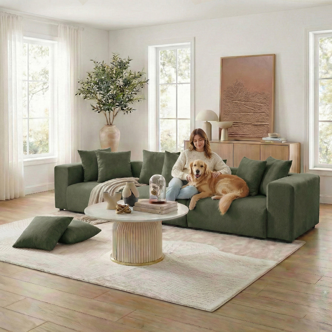 Woman and dog on green sectional sofa in styled living room