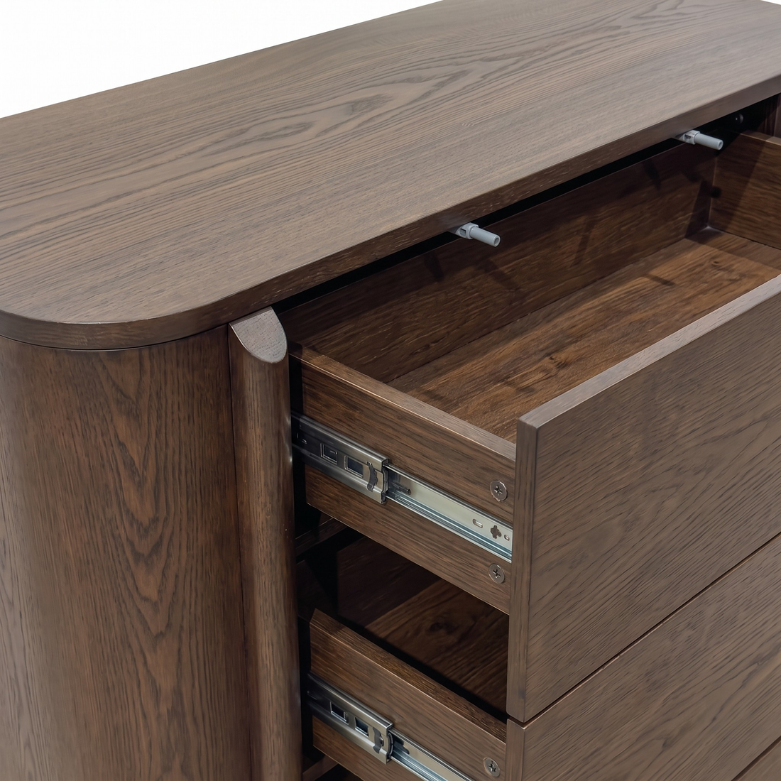 Partial view of a wooden dresser with some drawers open on a white background