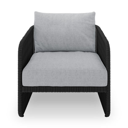 Solari 4 Seater Wicker Outdoor Sofa Set in Black features a sleek single-seat lounge chair, black woven frame, and thick light-gray cushions, epitomizing modern outdoor comfort and style.