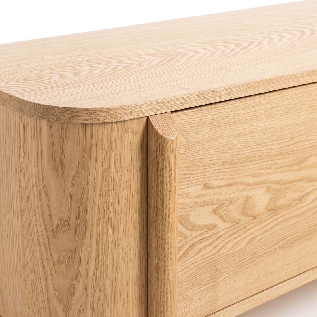 Close-up of a light oak wooden furniture corner showing wood grain and rounded edge