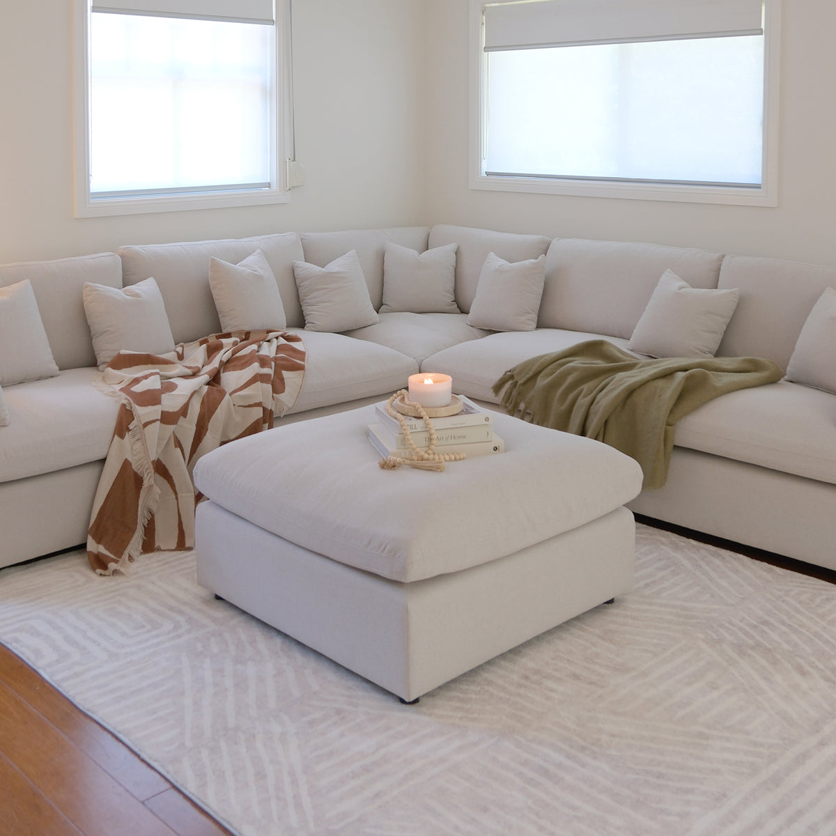 L-shaped sectional sofa with ottoman in a cozy living room