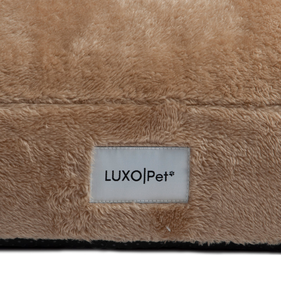 Detailed close-up of plush tan fabric and “LUXOPet” label