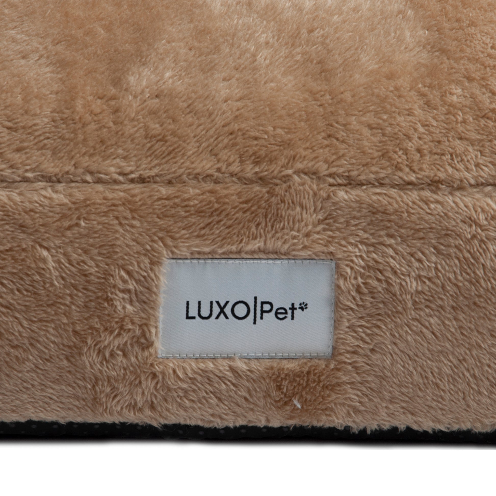 Detailed close-up of plush tan fabric and “LUXOPet” label