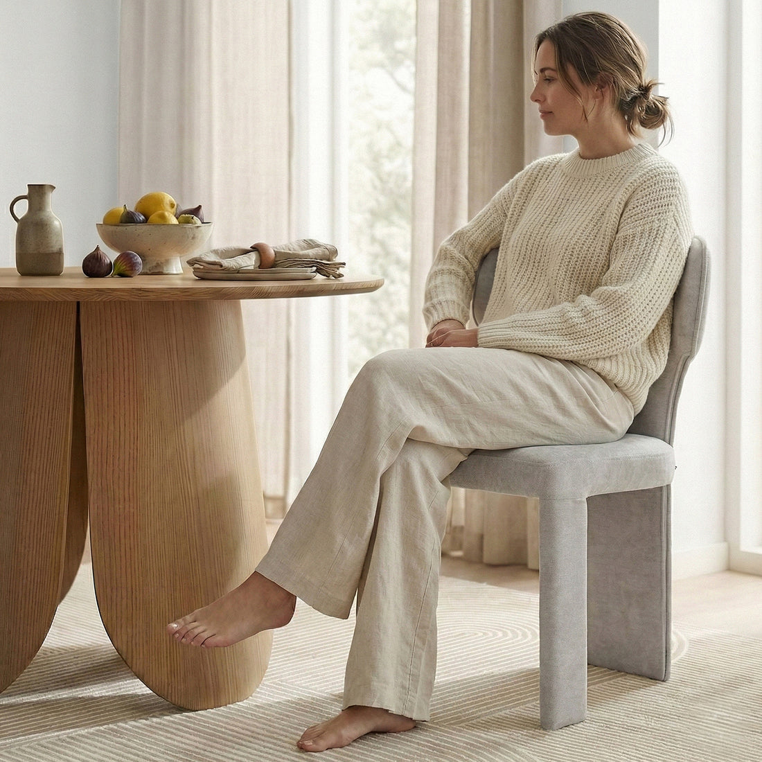 Partial view of wooden dining table with decor and person sitting next to it