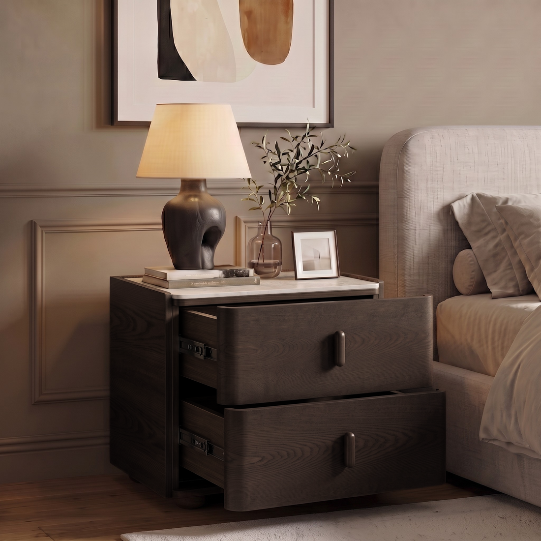 Dark wood nightstand styled in a bedroom beside a bed with lamp, books, and decorative accessories.