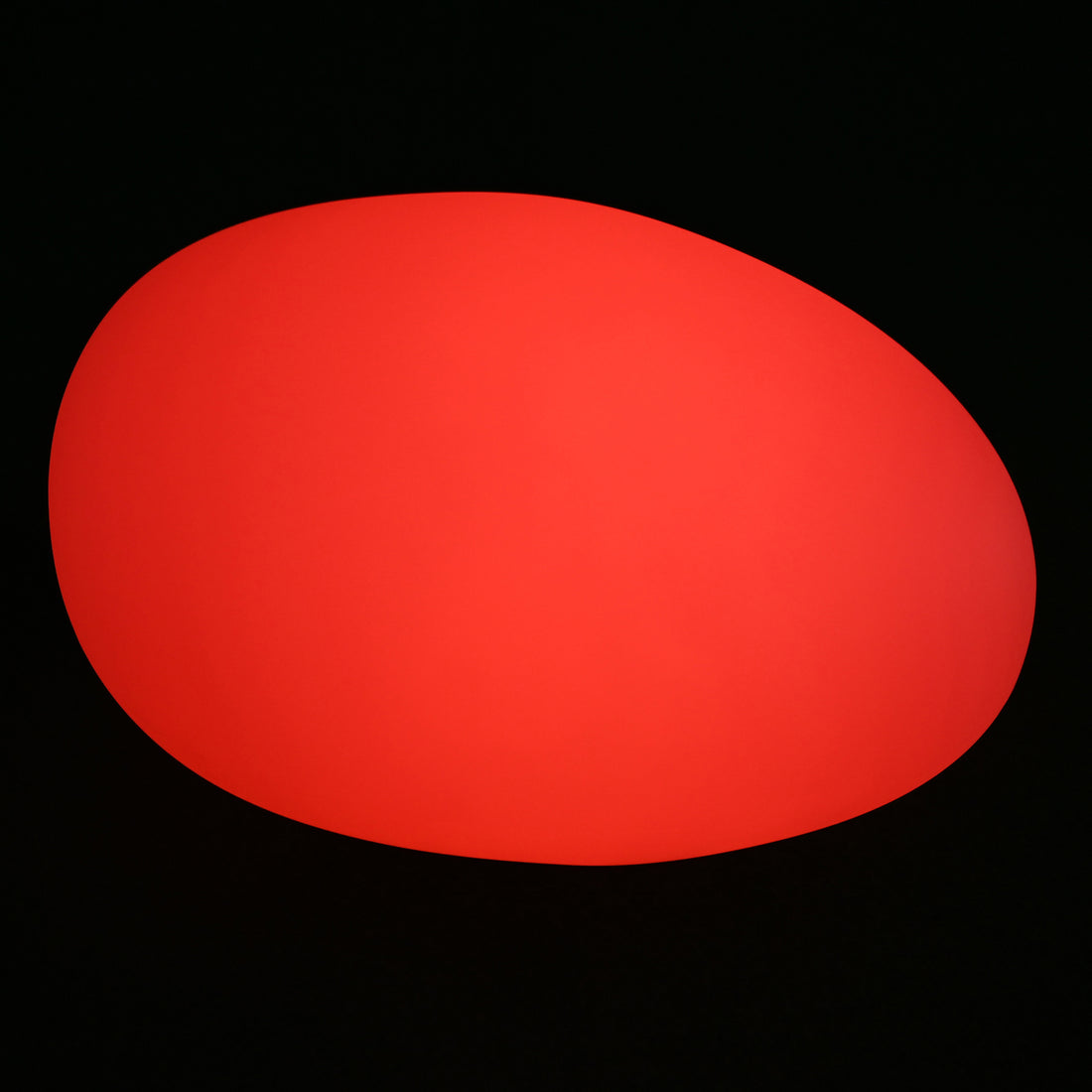 Solar Charging Outdoor LED Rock Light Waterproof Stone Lamp, depicted as a smooth, glowing red oval against a dark backdrop, illustrating its vibrant nighttime illumination feature.