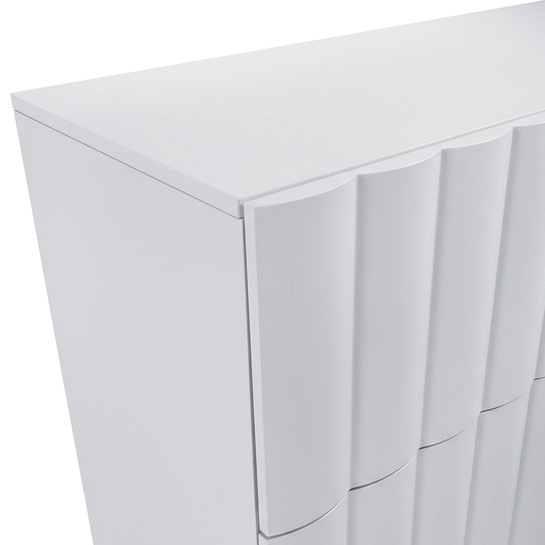 Angled view of top corner of white cabinet showing wavy front panels on white background