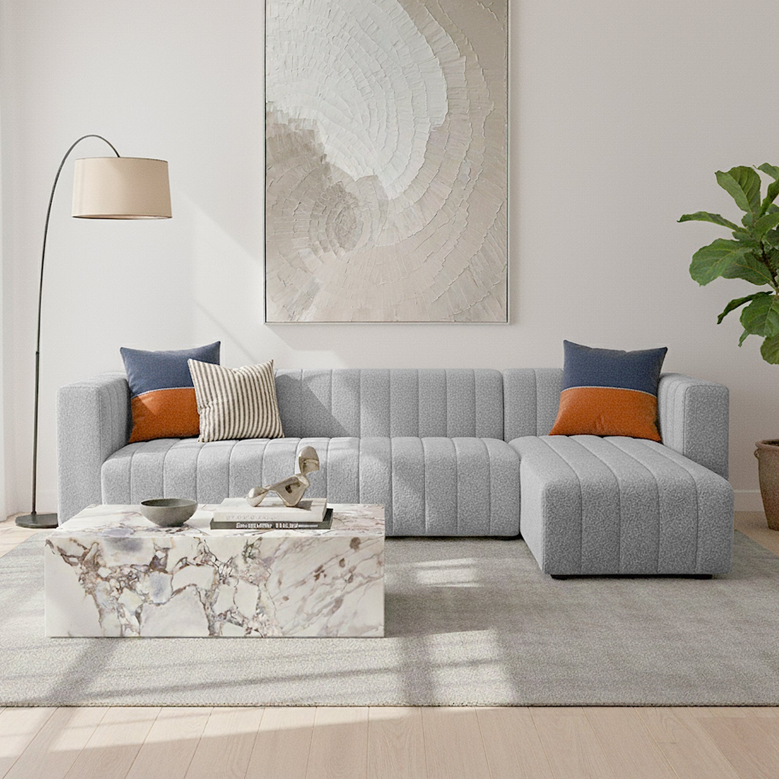 Parisa 4 Seater Tufted Boucle Sofa with Chaise in Light Grey features a channel-tufted design, plush seating, and a right-side chaise, set in a modern living room with a marble coffee table and abstract painting.
