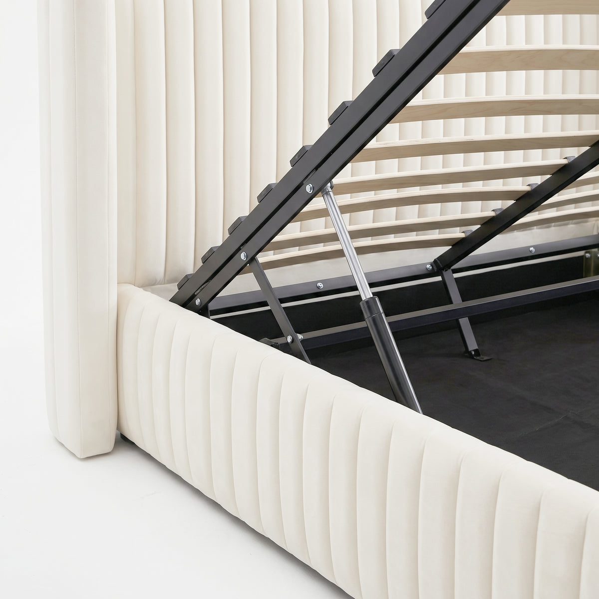 Close-up of upholstered storage bed lift mechanism and wooden slats