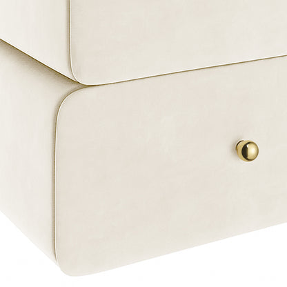 Luxo Tyla Modern Velvet Bedside Table Beige features a smooth cream finish with rounded corners, two drawers, and a polished brass knob, offering a stylish, compact design for bedroom functionality.