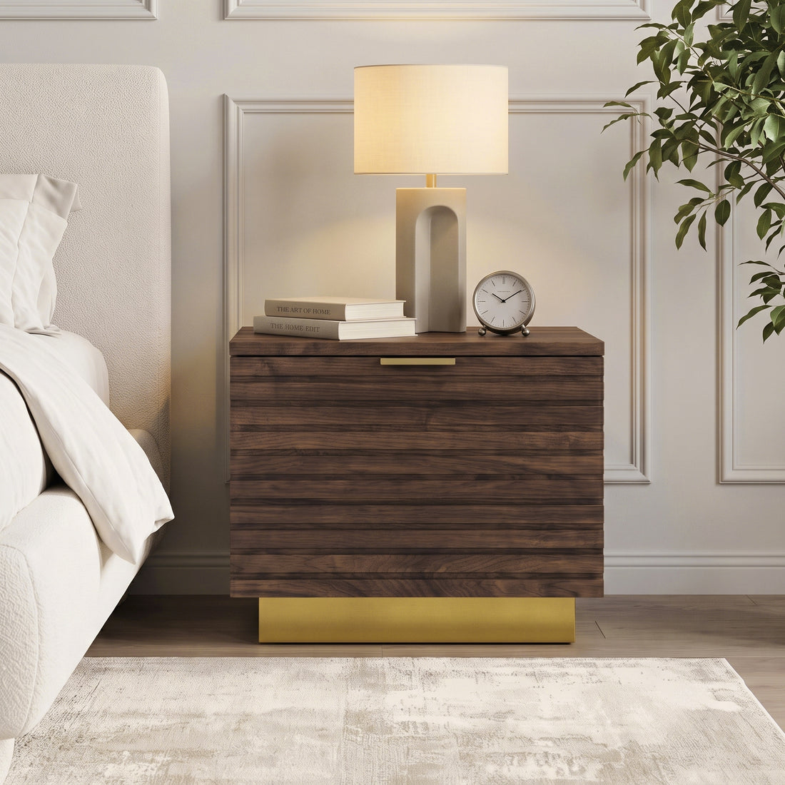 Dark wood nightstand styled beside a bed in a modern bedroom