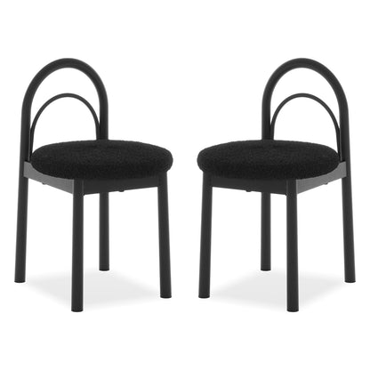 Two modern black chairs with curved backrests and padded seats on a white background