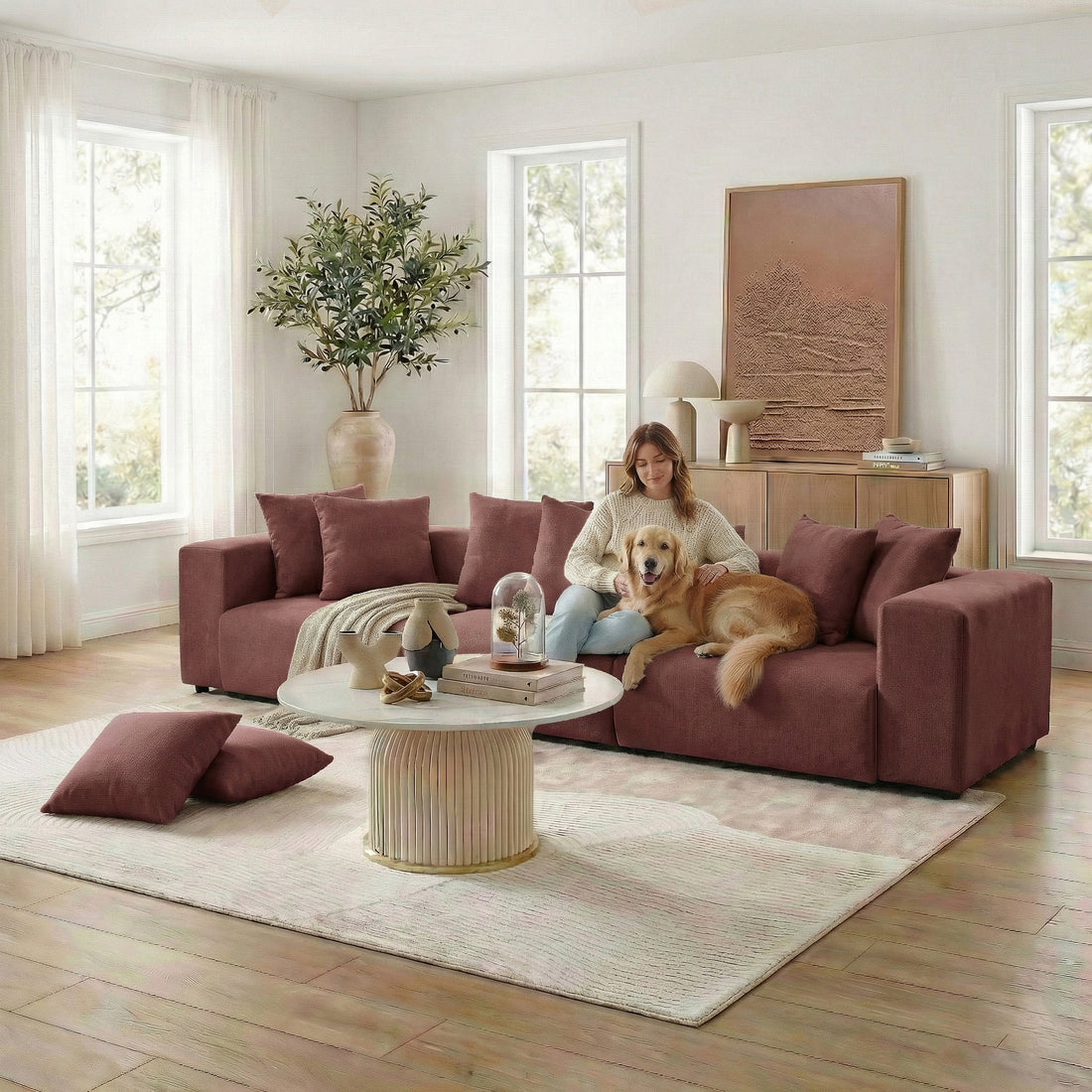 Living room scene with rust-red sectional sofa, person and dog, coffee table and decor