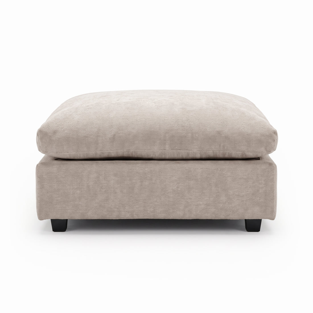 Beige upholstered ottoman with plush cushion on a white background.