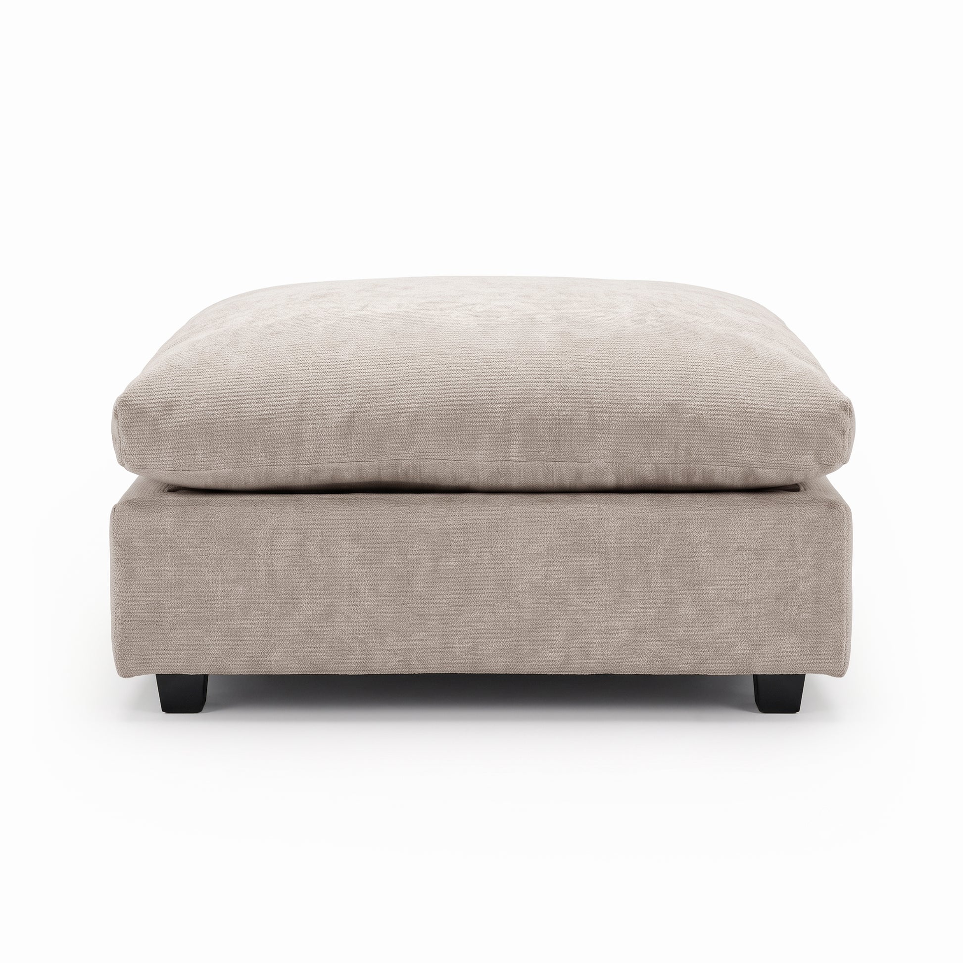 Beige upholstered ottoman with plush cushion on a white background.