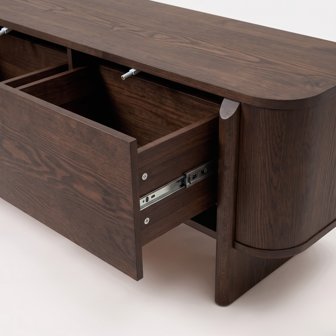 Close-up of a dark wood sideboard with an open drawer on a white background.