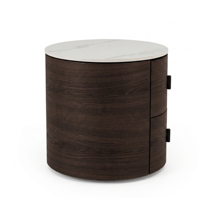 Round two-drawer side table with dark wood body and white marble-look top on a white background.