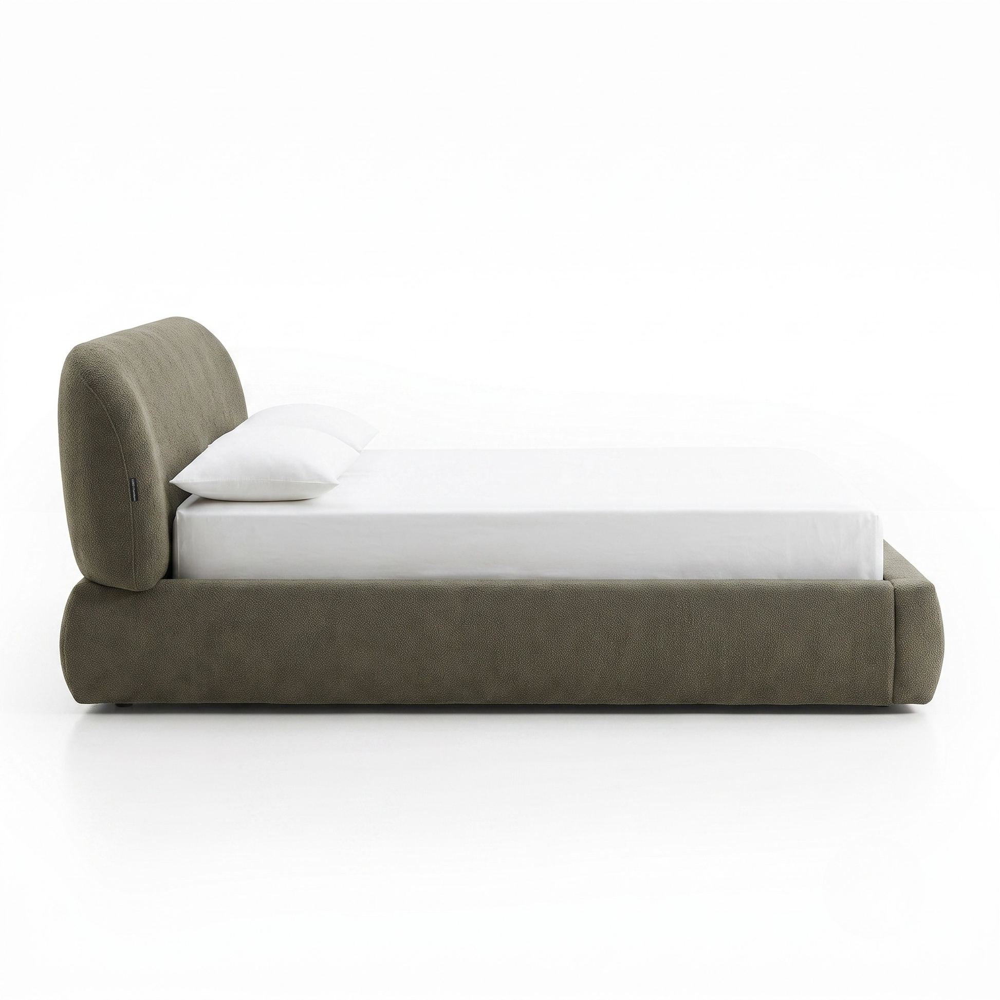 Side view of an upholstered bed on a white background