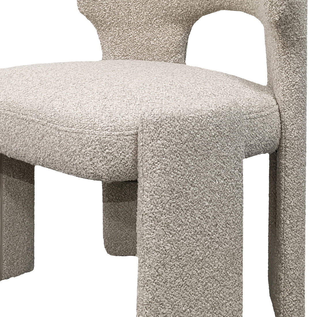 Lunari Bouclé Curved Accent Chair in Beige features a close-up of its cream-colored bouclé fabric, rounded seat, connected backrest, and chunky, slightly flared legs, offering compact comfort and style.