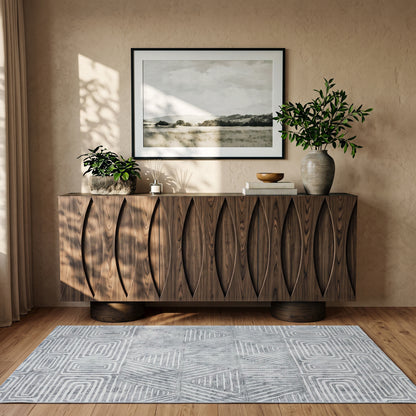 Modern wooden sideboard styled in a warm room setting with decor and artwork