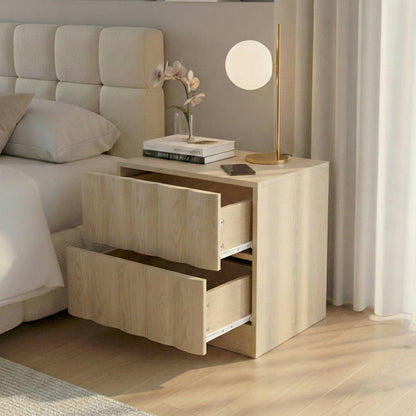 Nightstand with open drawers styled beside a bed in a sunlit bedroom