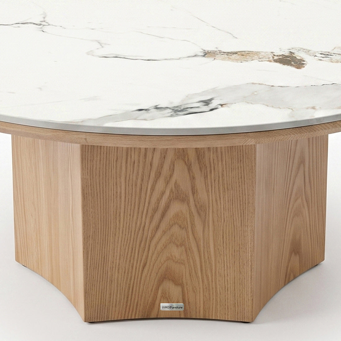 Close-up of the lower portion of a round coffee table with wood base and white tabletop