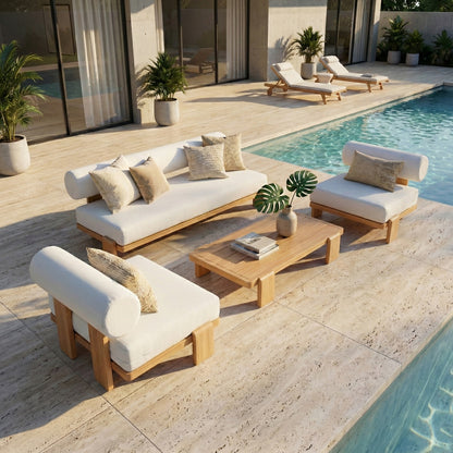 The Modica 5 Seater Aluminium Outdoor Sofa Set in White features a loveseat, two armchairs, and a low coffee table by a pool, surrounded by potted plants on a stone-tiled deck.