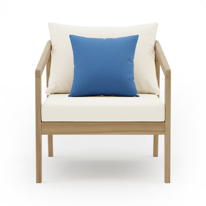 Delva 4 Seater Hardwood Acacia Outdoor Sofa Set in Cream featuring a modern armchair with a light-wood frame, white cushions, and a centered blue throw pillow.