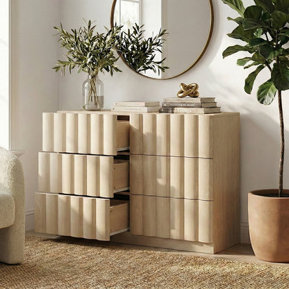 Light wood six-drawer dresser with three drawers open in a modern room setting
