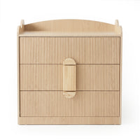 Light wood three-drawer dresser with fluted drawer fronts and raised edges on a white background