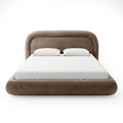 Front view of a rounded taupe upholstered bed with white bedding on a white background
