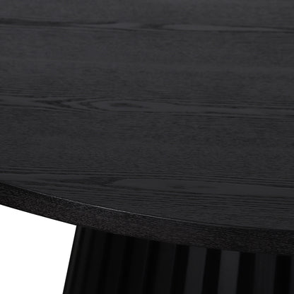 Close-up of the Riri 120cm Round Fluted Wood Dining Table in Black, highlighting its textured wood grain tabletop and the elegantly fluted black pedestal base, showcasing sculptural design and practical elegance.